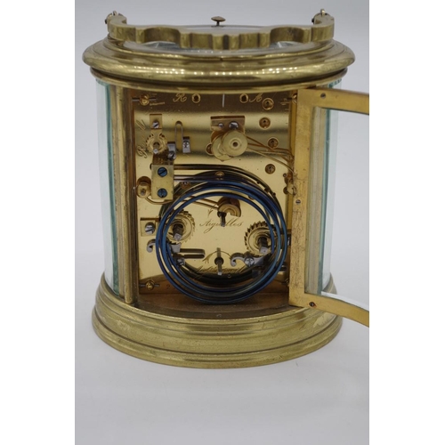 1324 - A good antique brass oval grande and petite sonnerie carriage clock, with alarm and push button repe... 