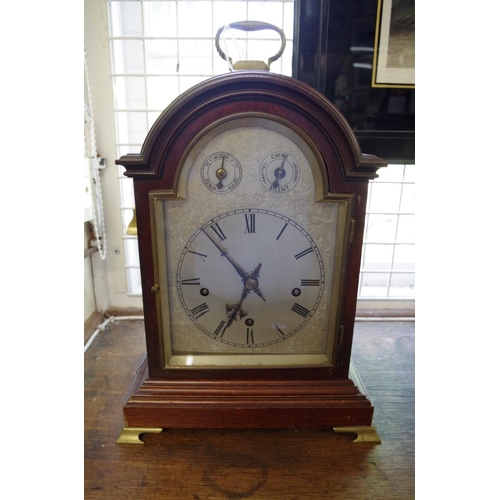 1344 - An early 20th century mahogany musical mantel clock, with arched silvered dial, striking on fiv... 