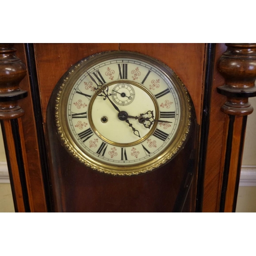 1352 - A Vienna style walnut and ebonized wall clock, the dial with subsidiary seconds, 127cm high, with pe... 