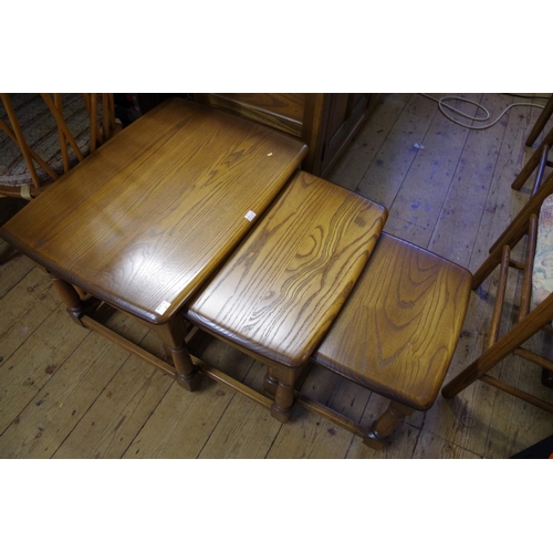 1410 - A nest of three Ercol 'Golden Dawn' tables, largest 61cm wide; together with a matching demi-lune si... 