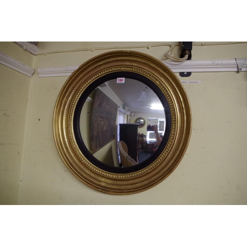 1381 - An antique gilt framed circular convex wall mirror, 54cm diameter. 