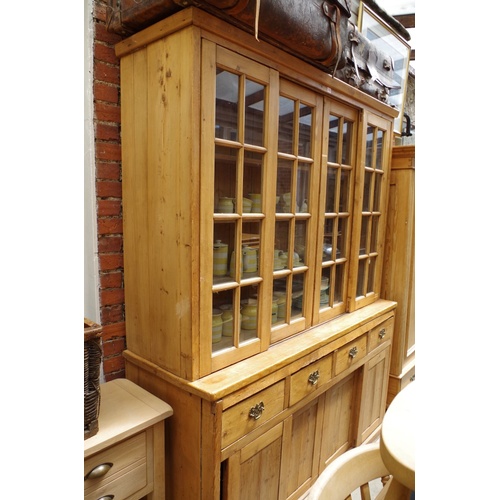 1003 - An old pine kitchen cabinet, with two pairs of sliding glass panel doors, 173cm wide.... 