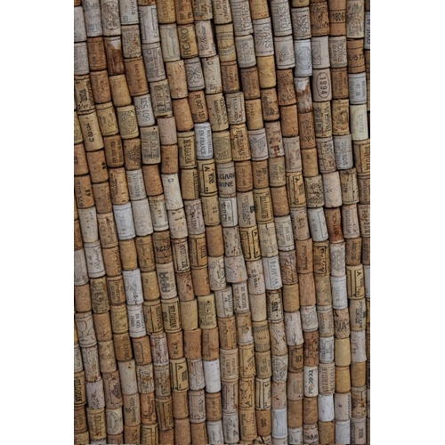 1031 - A framed display of bottle corks, 100cm wide x 84cm high.