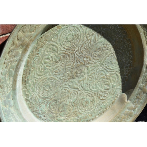 1073 - A large Eastern brass tray; together with a smaller example.
