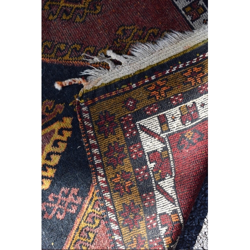 1083 - A large Afghan runner, having two central diamonds with geometric borders, 366 x 102cm.... 