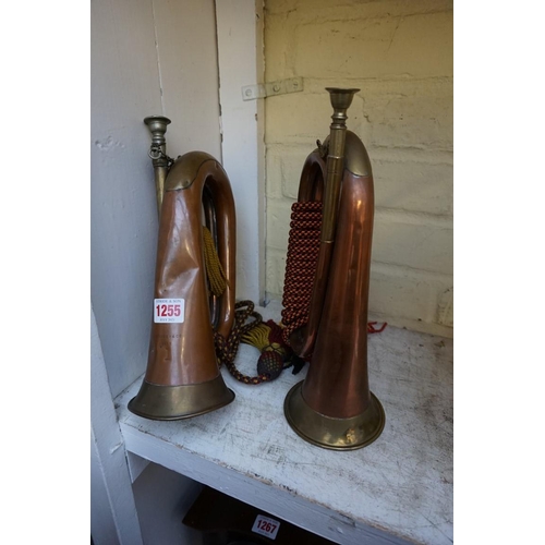 1255 - Two antique copper and brass bugles, one inscribed 'Boosey & Co, 1915', and with broad arrow mar... 