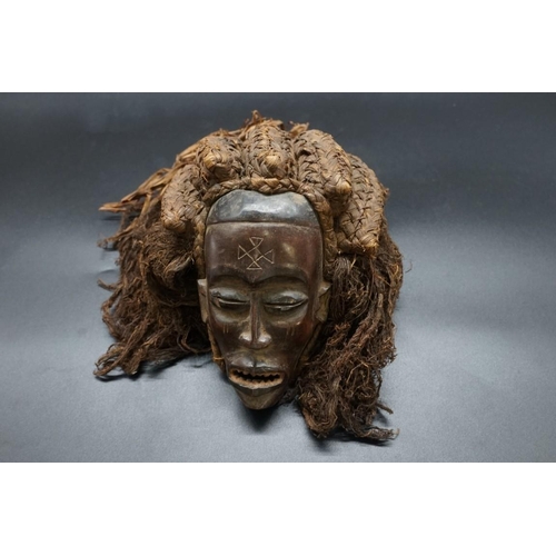 1449 - Ethnographica: a Baule tribal mask, Cote d'Ivoire, with an elaborate fibre back, 21cm.... 