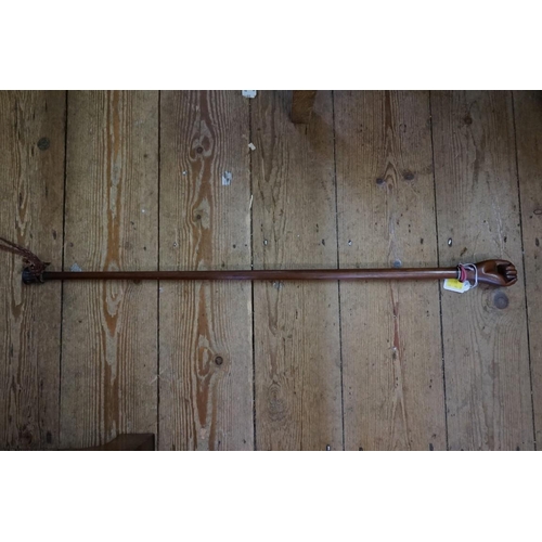 1910 - A hardwood cane, with clenched fist terminal.