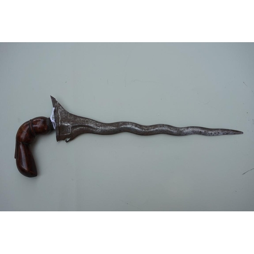 1915 - An Indonesian kris, possibly Sumatran, with 32cm wavy blade and well patinated hilt.... 