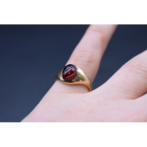 84 - A yellow metal cabochon garnet ring, stamped 18ct, size S.