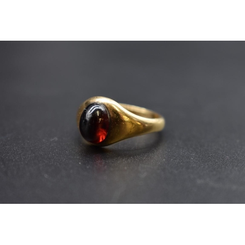 84 - A yellow metal cabochon garnet ring, stamped 18ct, size S.