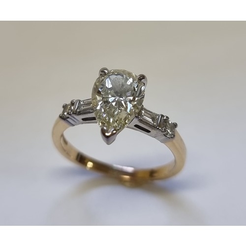 307 - A 18ct white and yellow gold diamond ring, set central pear shaped yellow diamond of 2.06ct with a b... 