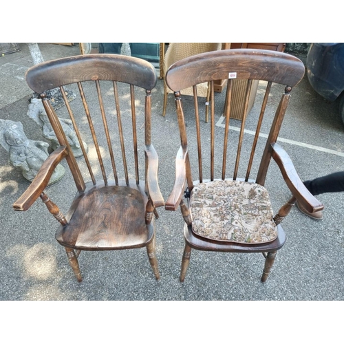 1014 - A pair of oak stickback elbow chairs. 