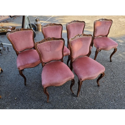 1023 - A set of six Victorian carved rosewood dining chairs. 