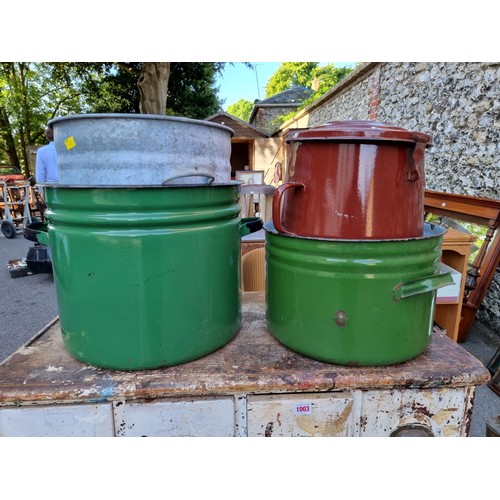 1002 - Three enamel pots; together with a metal twin handled pot.