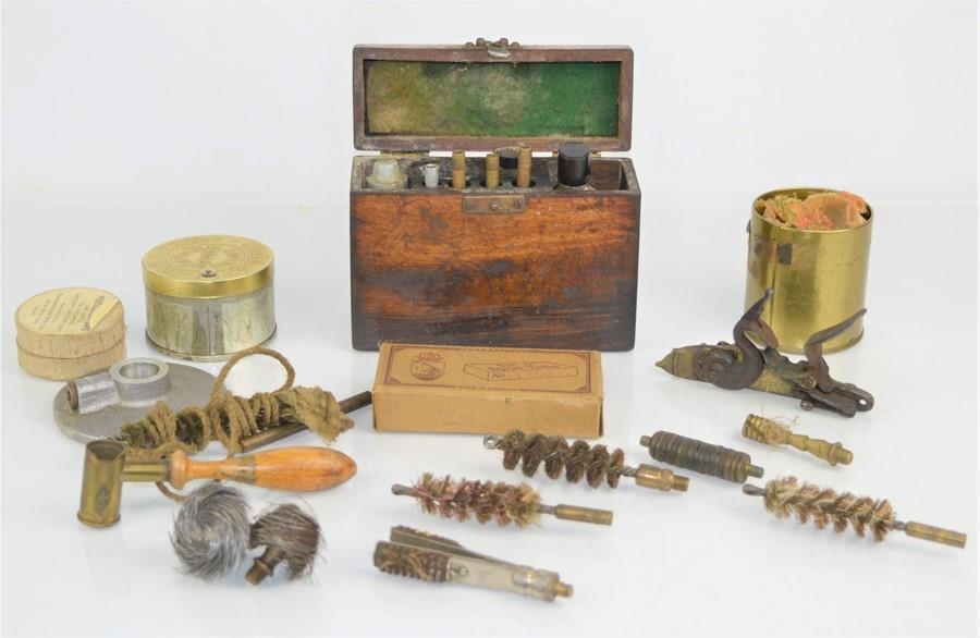 An early 20th century gun cleaning kit in a wooden box together with a ...