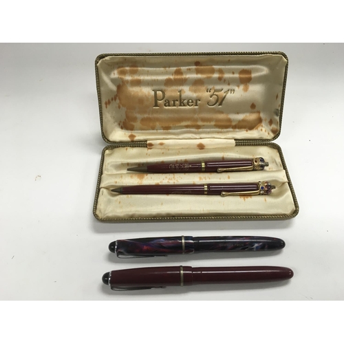 705 - Two Queen Elizabeth II Coronation pens and two Osmiroid fountain pens.