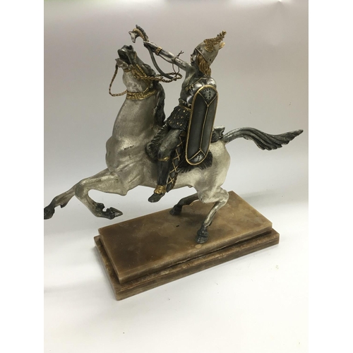 706 - A heavy bronzed figure of a mythical warrior on horseback, raised on a marble base, approx total hei... 