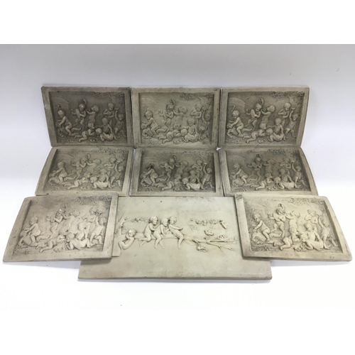707 - A box of marble plaques depicting putti.