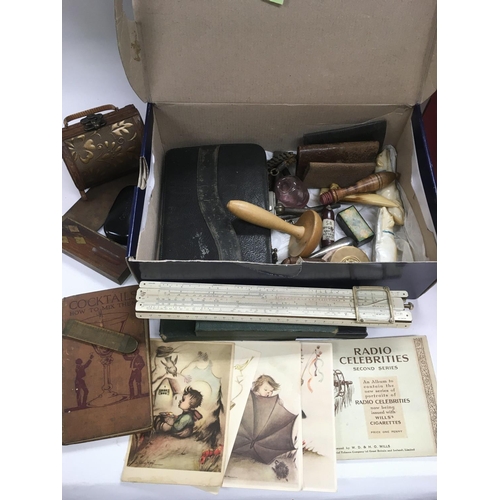 719 - Two boxes of oddments comprising netsuke, cigarette cards, dressing table items etc.