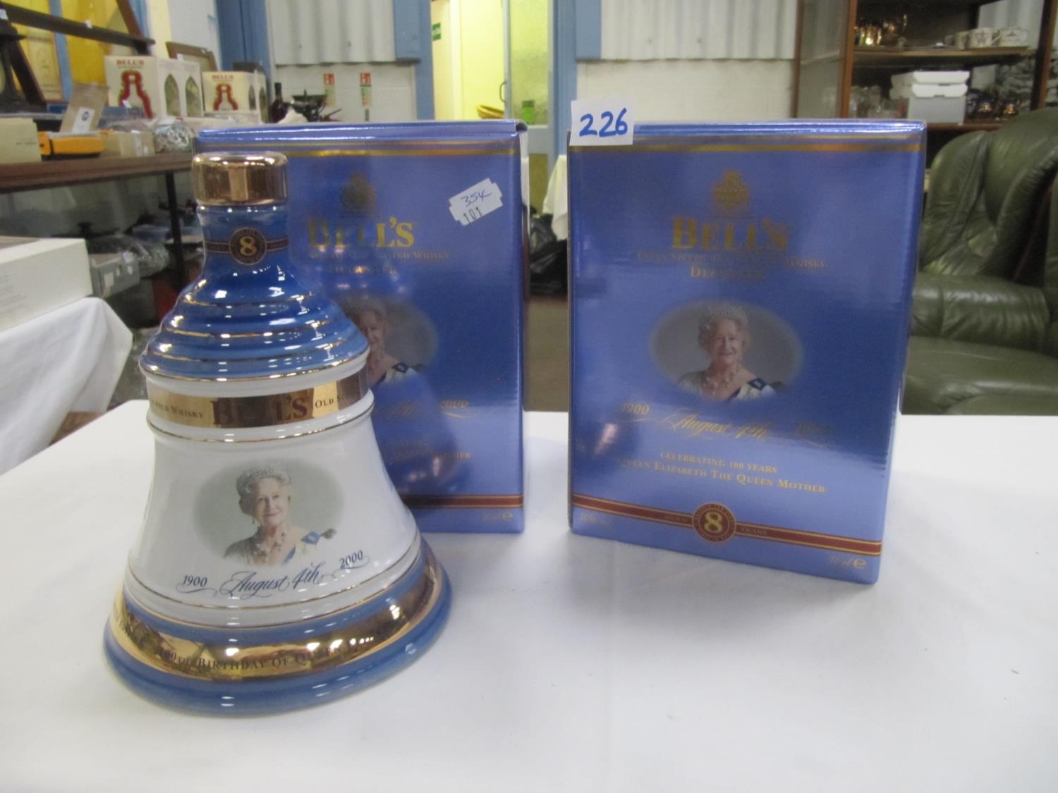 Two Boxed Sealed and Full Bells Whiskey Decanters Celebrating 100 Years of The Queen Mother.