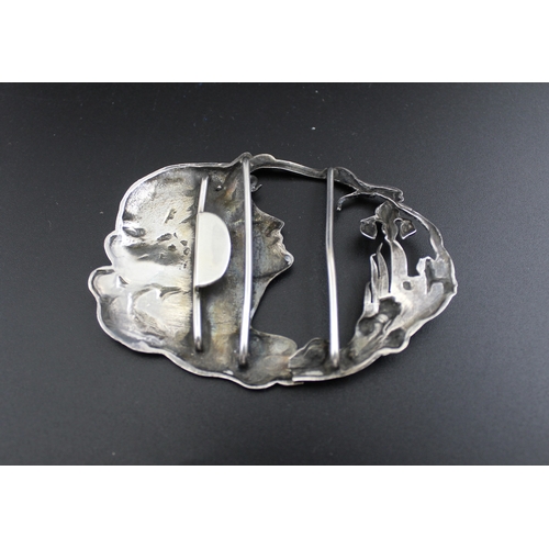 26 - Arthur Johnson Smith, an Art Nouveau silver belt buckle, of oval form, cast with a lady's face in pr... 