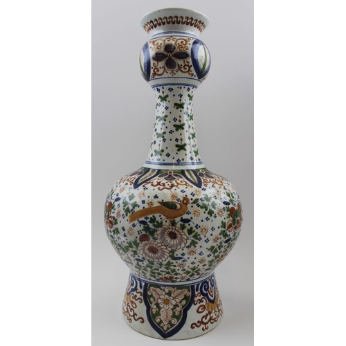 61 - A pair of polychromed Delft pottery vases, in the form of Oriental garlic necked examples, 41cm high