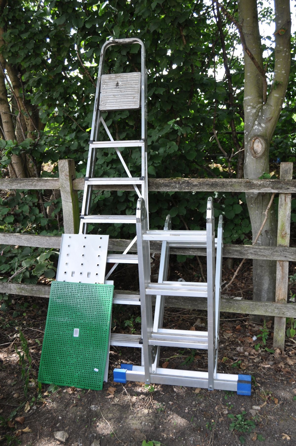 AN ALUMINUM FOLDING PLATFORM LADDER With Three Rungs To Each Of The 