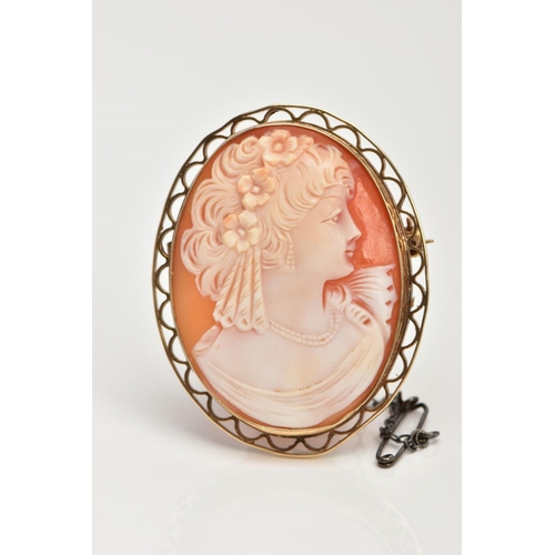 34 - A PORTRAIT CAMEO BROOCH, set in an a 9ct gold open work mount, portrait depicting a lady facing to t... 
