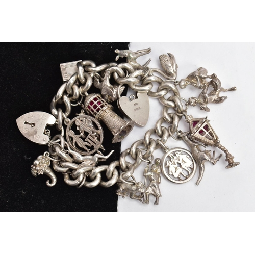 34 - A SILVER CHARM BRACELET, a curb link bracelet each link stamped sterling, fitted with a heart shaped... 