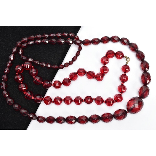 58 - TWO SETS OF FACETED CHERRY AMBER PLASTIC BEAD NECKLACES, the first designed with circular faceted be... 