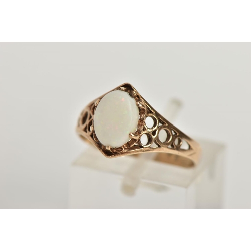 26 - A 9CT GOLD OPAL RING, designed with an oval opal cabochon in a six claw setting, openwork detailed s... 