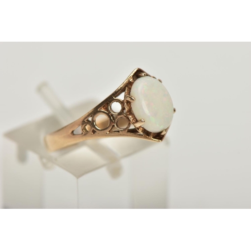 26 - A 9CT GOLD OPAL RING, designed with an oval opal cabochon in a six claw setting, openwork detailed s... 