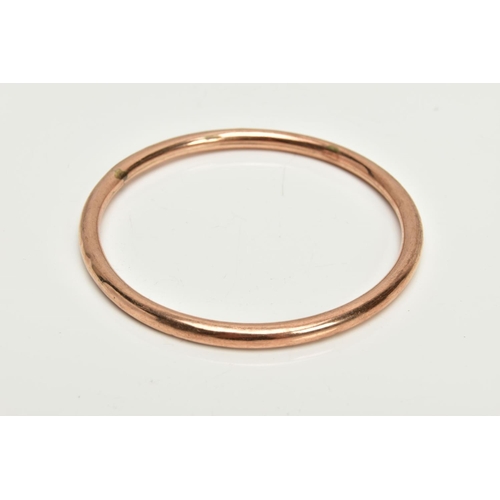 46 - A ROSE GOLD TONE BANGLE, plain polished hollow bangle, stamped 9ct, approximate internal diameter 67... 
