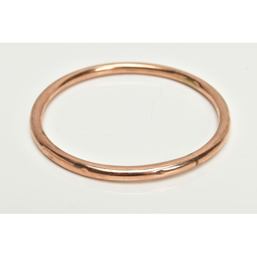 46 - A ROSE GOLD TONE BANGLE, plain polished hollow bangle, stamped 9ct, approximate internal diameter 67... 