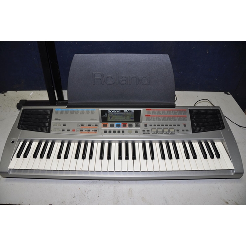 A ROLAND EM15 ELECTRIC KEYBOARD with sheet music holder and keyboard stand (PAT pass and working)