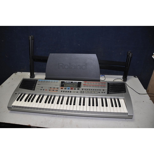 A ROLAND EM15 ELECTRIC KEYBOARD with sheet music holder and keyboard stand (PAT pass and working)