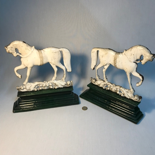 A Pair Of Antique White And Green Enamel Cast Iron Door Stops Of