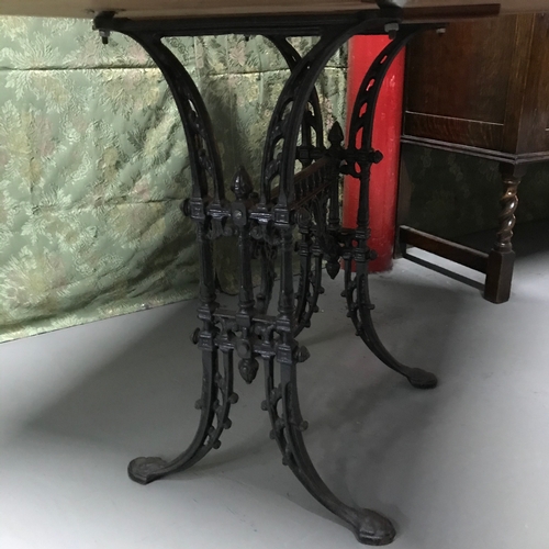 134A - A Heavy cast iron base, solid light oak top table, Ideal for kitchen table. Measures 71x90x75cm