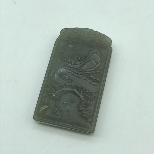 598J - A Finely carved Chinese hand carved jade pendant/ sculpture depicting a landscape/ fishing scene.