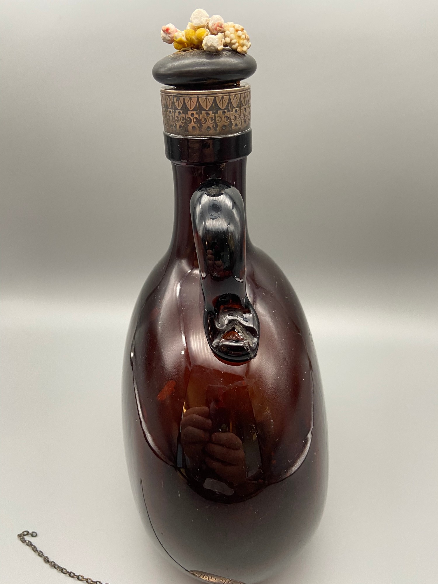 A Victorian brown glass whisky flagon designed with a possible silver ...