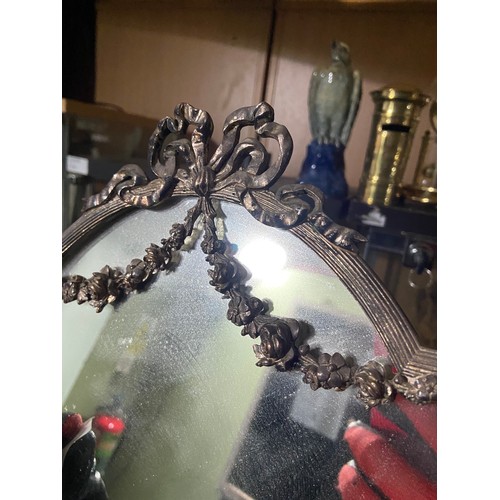 479 - A Regency style plated wreath and ribbon design dressing table mirror.