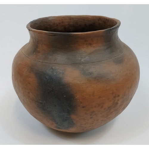 121 - An African tribal clay pottery cooking pot. [31cm in height]
