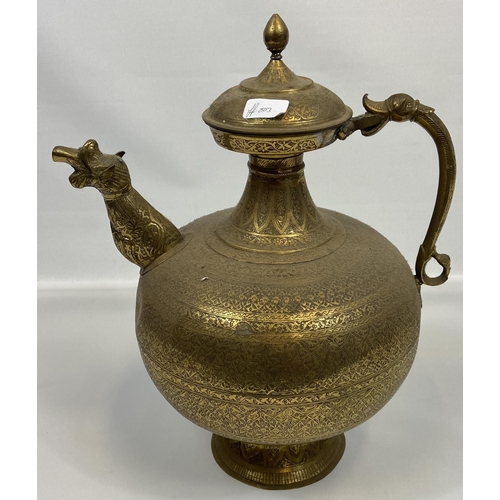 122 - A Large antique Indian gilt brass engraved tea pot. Designed with a dragon style head spout and hand... 