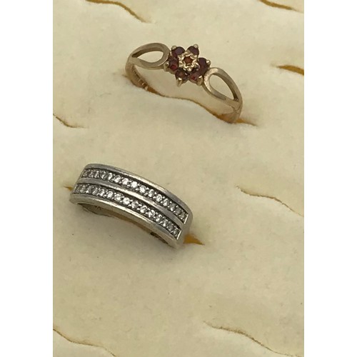 18 - A Ladies 9ct yellow gold and garnet ring, together with a 9ct white gold and CZ ring. [4.62grams]