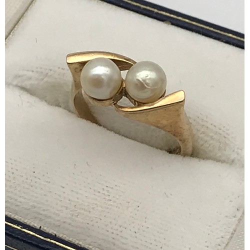 10 - A Ladies 9ct yellow gold and two pearl set ring. [Ring size L] [3.82Grams]