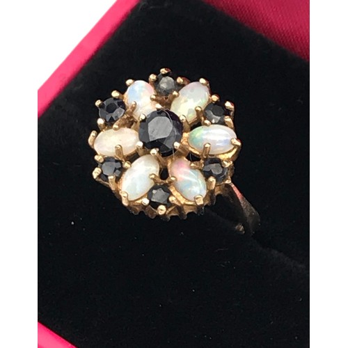 3 - A Ladies 9ct yellow gold opal and sapphire floral design ring. [Ring size][3.27grams]