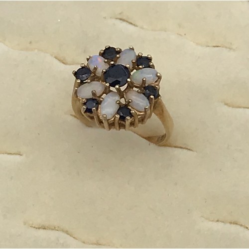 3 - A Ladies 9ct yellow gold opal and sapphire floral design ring. [Ring size][3.27grams]