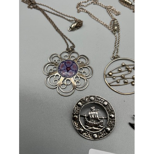 32 - A Lot of silver jewellery to include three pendants with chains and two Celtic design brooches.