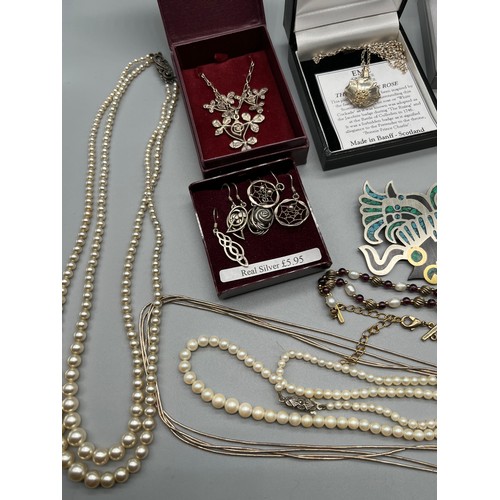 34 - A Quantity of silver jewellery to include necklaces, earrings, bangles, and pearl necklaces.